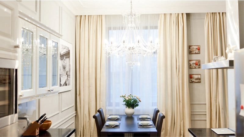 Tulle with curtains in the interior of a classic kitchen