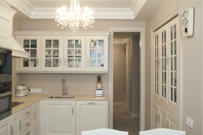 White kitchen with beige walls in a classic style.