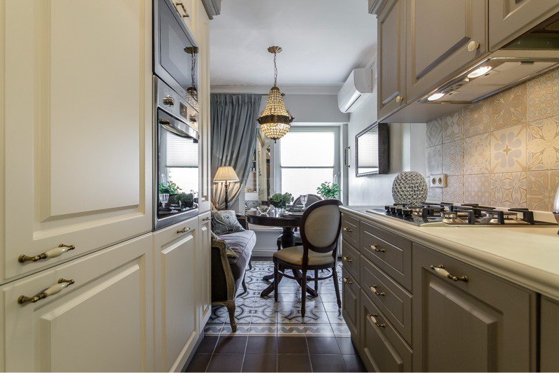 Narrow kitchen with white and gray cabinets