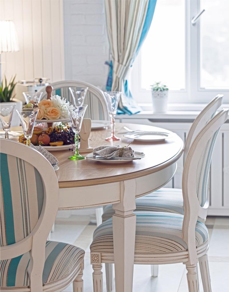 Wooden round table in the interior of the kitchen