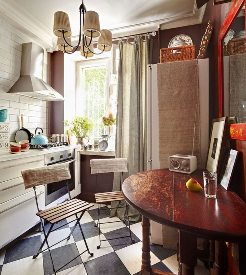 Wooden folding table of semicircular shape in the interior of a small kitchen