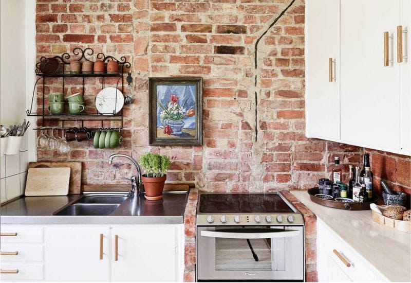 Brick wall in the interior of the kitchen in a rustic style