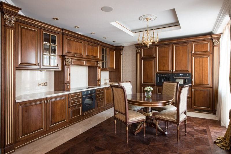 Round wooden table in the interior of a classic kitchen