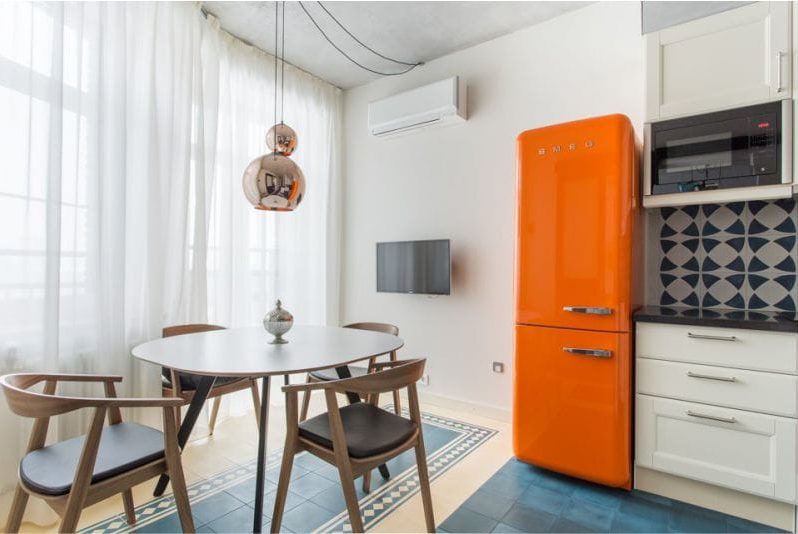 Oval wooden table in the interior of the kitchen in a modern style.