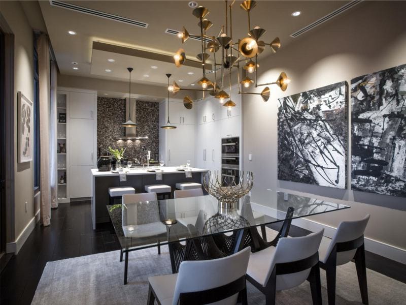 Glass table in the interior of the kitchen combined with the dining room and living room