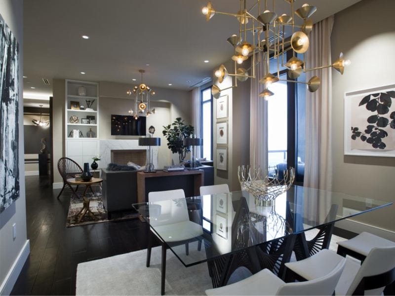 Glass table in the interior of the kitchen combined with the dining room and living room