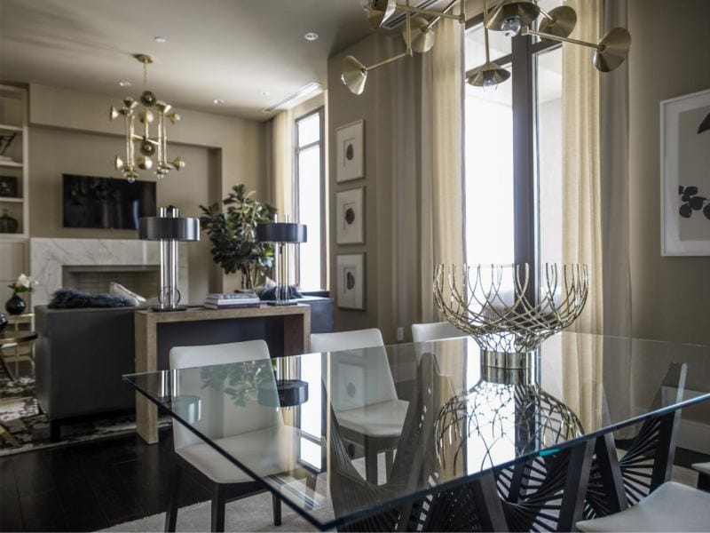 Glass table in the interior of the kitchen combined with the dining room and living room