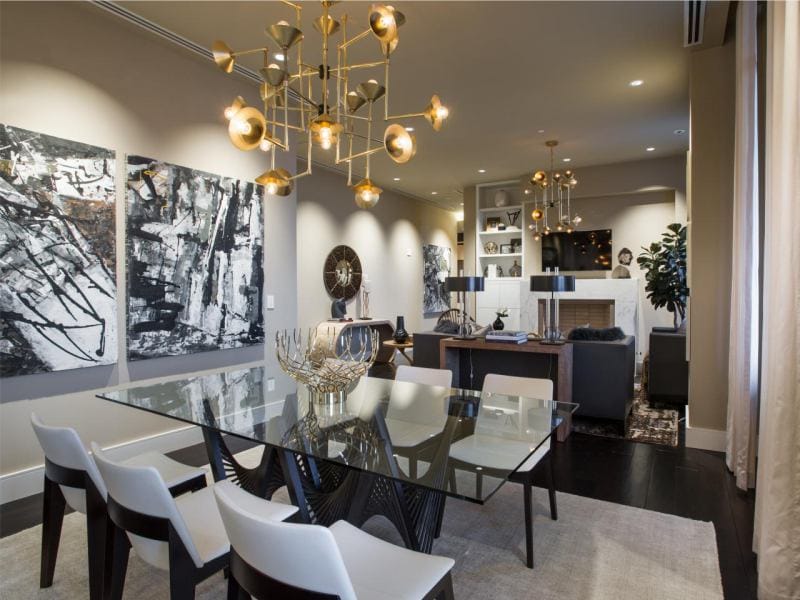 Glass table in the interior of the kitchen combined with the dining room and living room