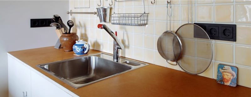 Square stainless steel sink in the interior of the kitchen