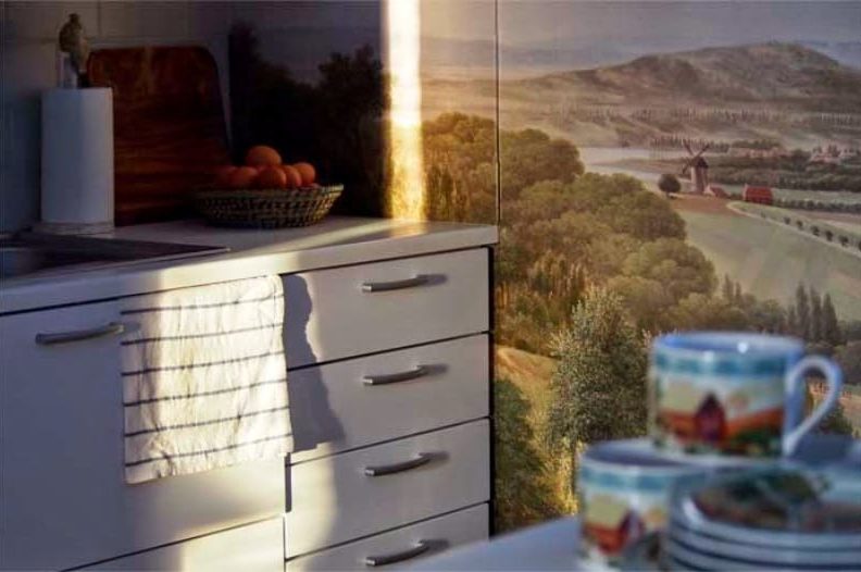 Photowall-paper with a landscape in an interior of kitchen