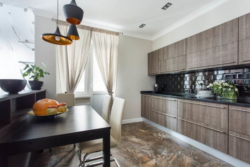 Black color and light wood in the interior of the kitchen