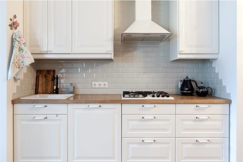 Gray apron in the interior of the white kitchen