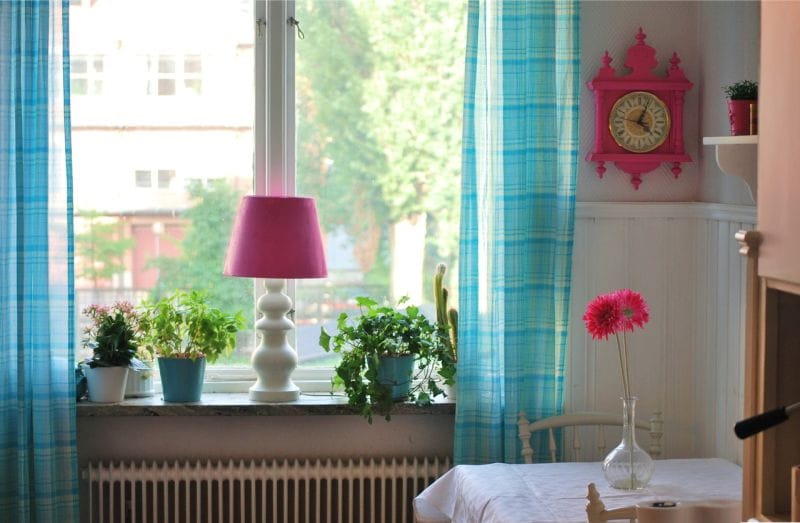 Blue curtains in the interior of the kitchen