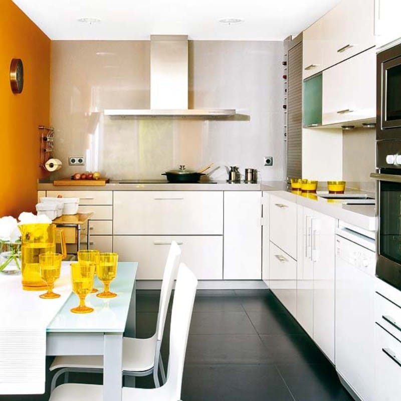 Accent wall of orange color in the interior of the kitchen with low ceilings