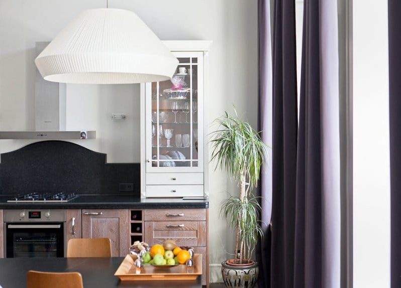 Neoclassical style kitchen with dark purple curtains