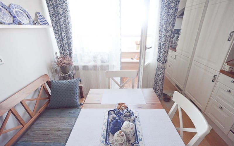 Interior of white and blue kitchen with Gzhel painted dishes