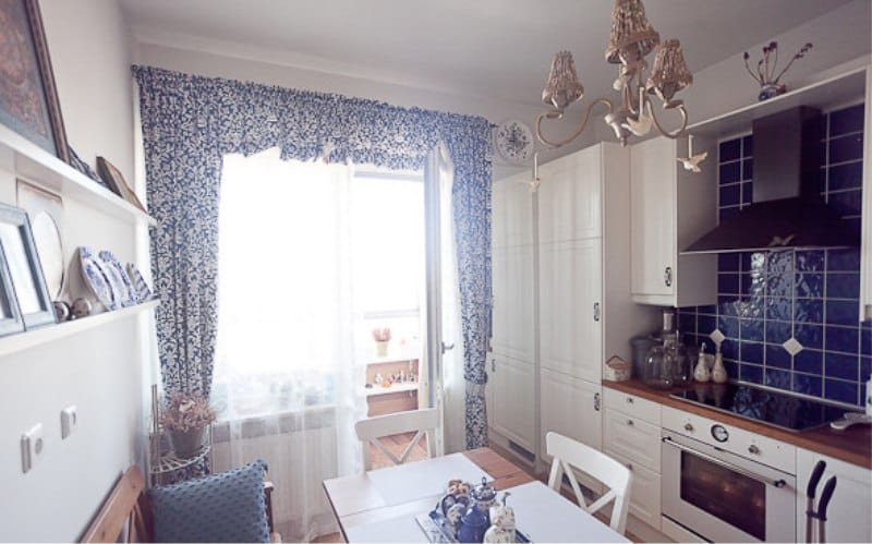 Interior of white and blue kitchen with Gzhel painted dishes