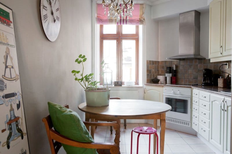 Striped Roman curtains in the interior of the kitchen in the style of Provence