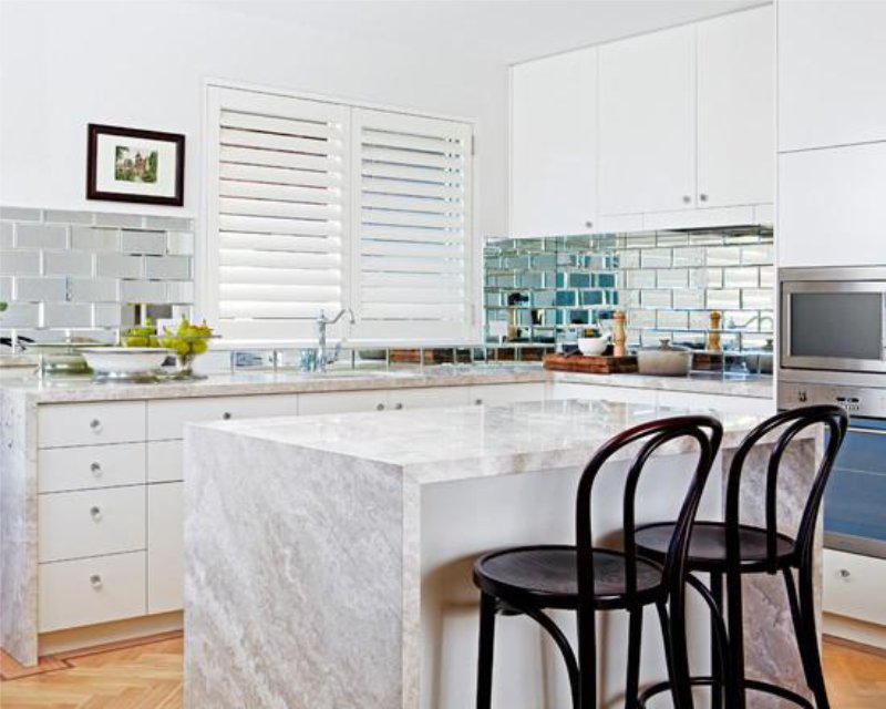 Apron from a mirror tile in an interior of kitchen