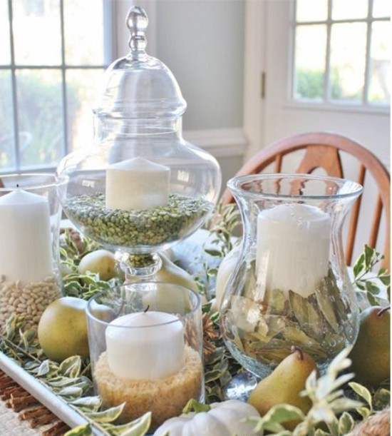 Candles with green peas in the spring table setting