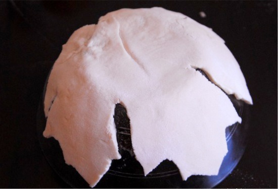 Laying the dough on a bowl, coated with oil