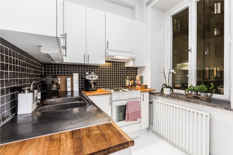 Black apron in the interior of the white kitchen