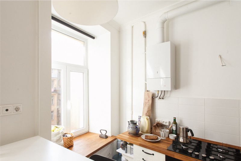 Geyser in the interior of the kitchen with white walls