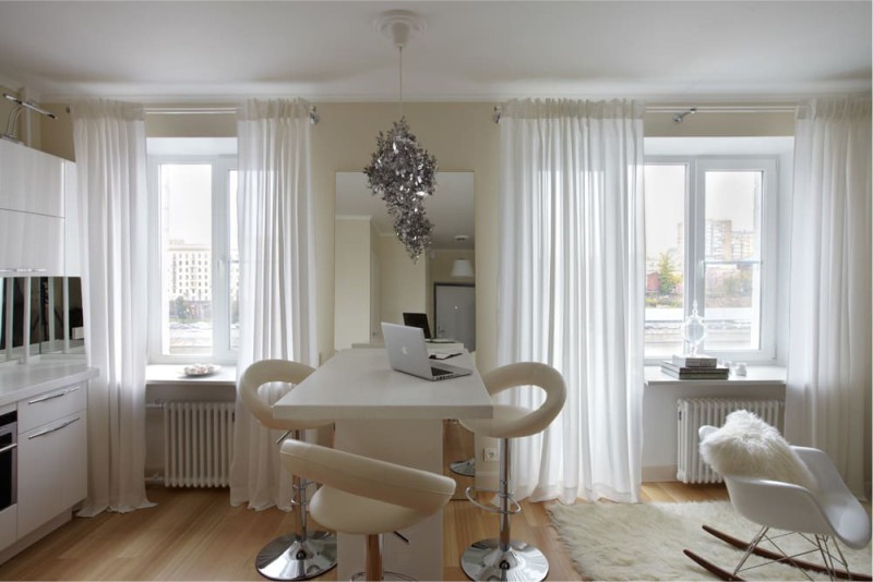 The mirror in the interior of a small kitchen-living room