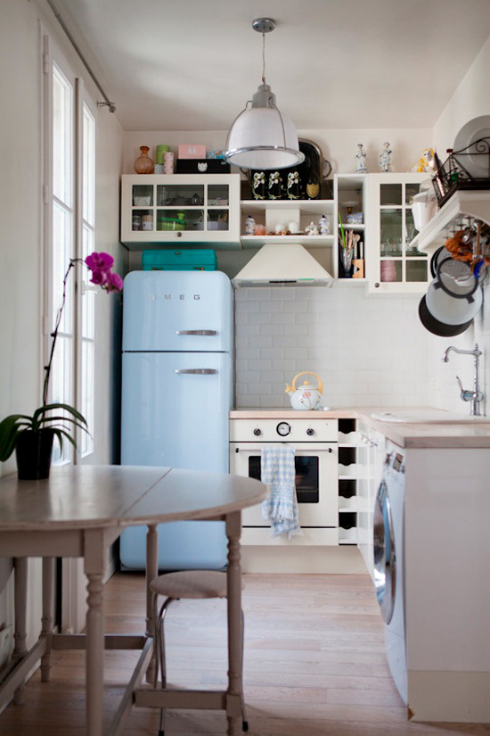 Kitchen with washing machine under countertop