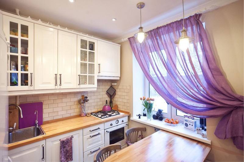 Violet curtains in tune to kitchen accessories