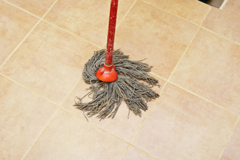 Washing the tile floor from grout residues