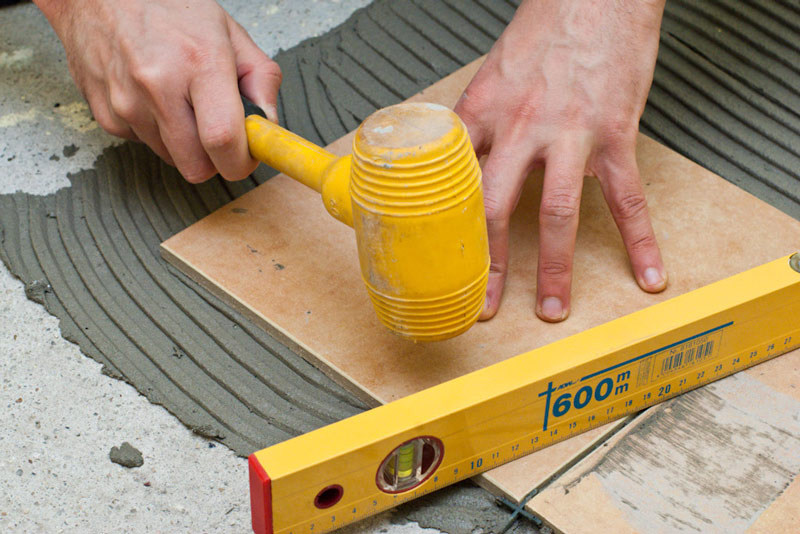 Aligning the tile with a mallet