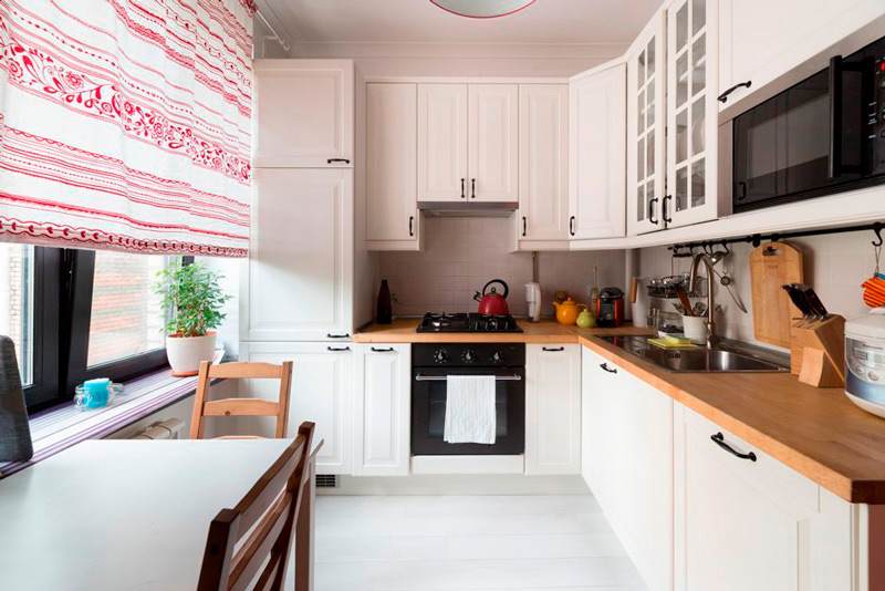 Horizontal striped curtain in the interior of a small kitchen.