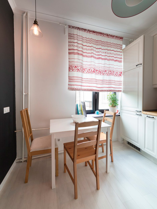 Horizontal striped curtain in the interior of a small kitchen.