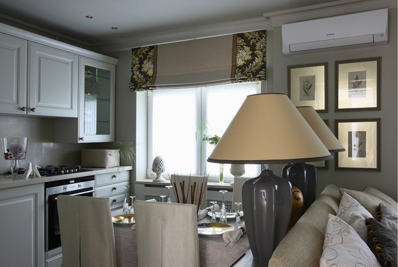 Roman curtains in the interior of a classic kitchen-living room