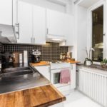 Black apron in the interior of the white kitchen