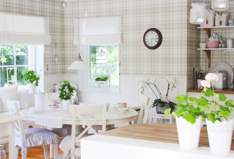 Two windows in the kitchen-dining room with a sofa