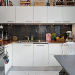 Mosaic apron in modern kitchen with wooden countertop