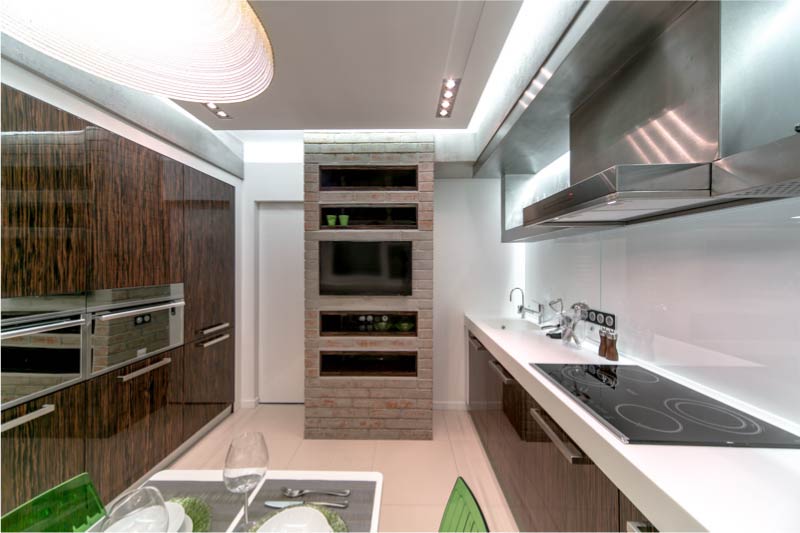 Kitchen with a parallel layout and a table in the center.