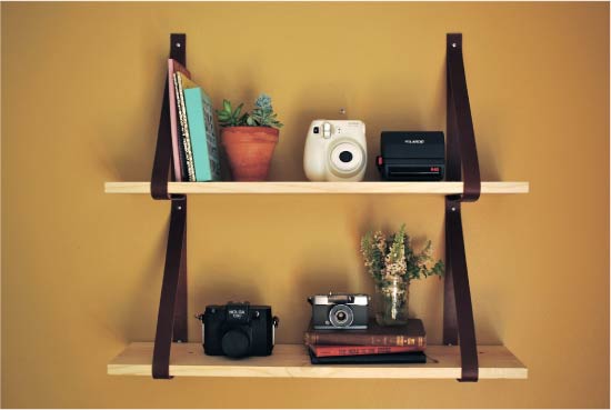 Shelf made of boards and leather belts