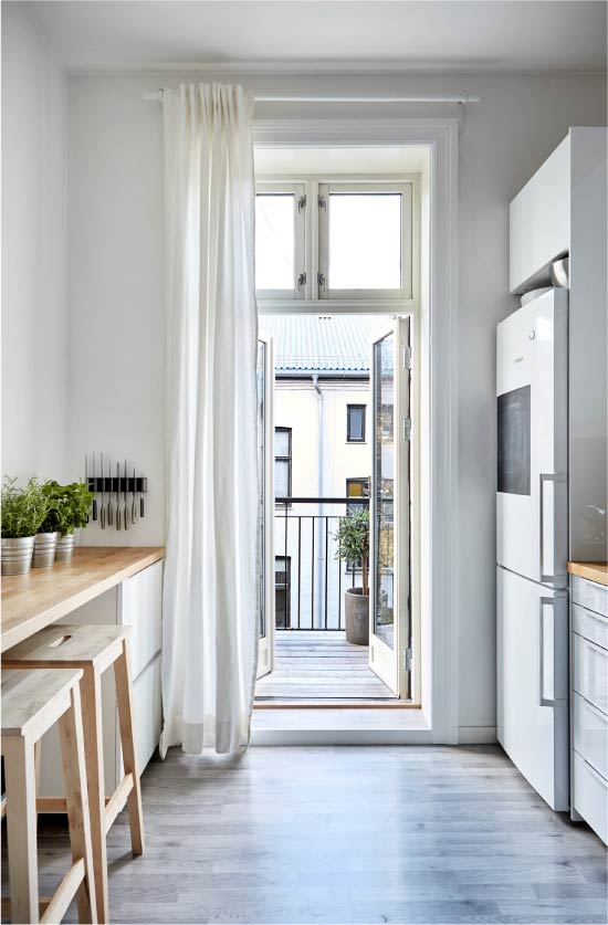 One curtain on the balcony door in the kitchen