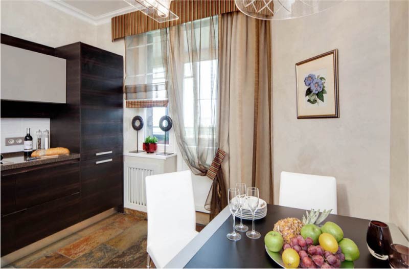 Roman curtains on the window with a balcony door in the kitchen