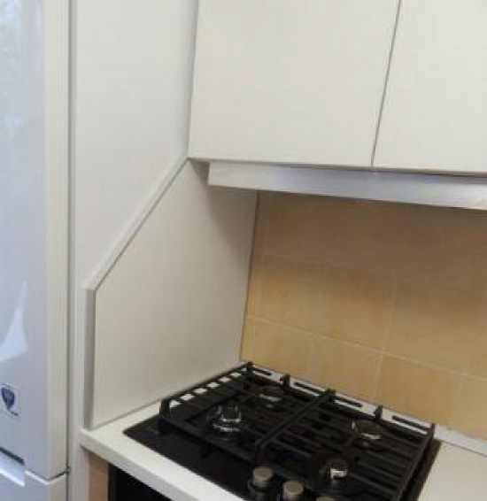 The screen between the stove and the refrigerator