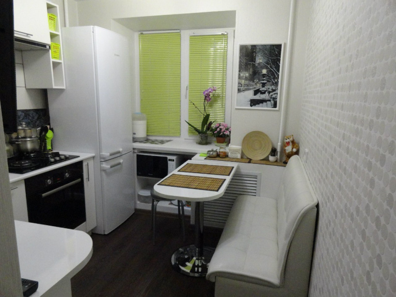 Refrigerator next to the gas stove and oven